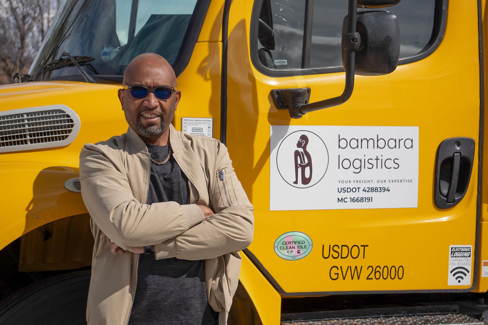 Founder Mo Doucoure standing in front of the Bambara Logistics 26-foot box truck in Salt Lake City