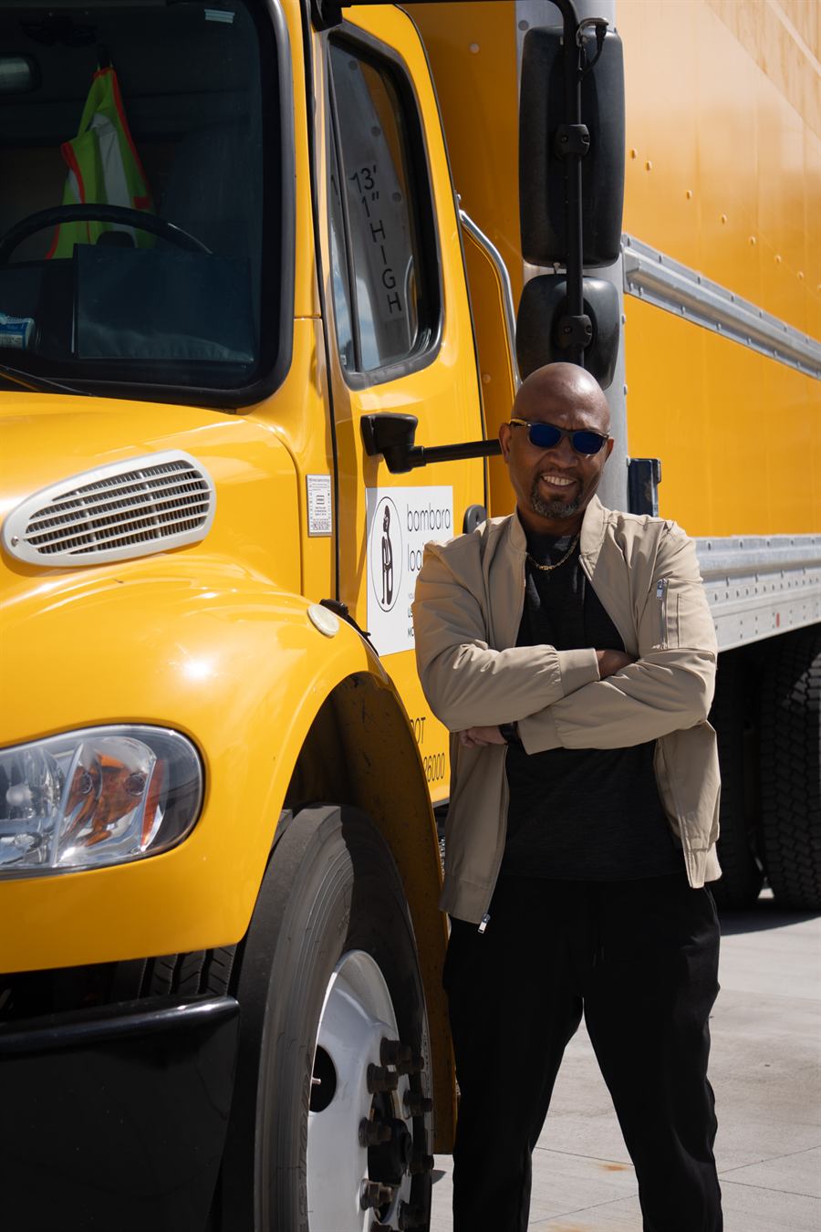 Mo Doucoure standing beside the Bambara Logistics 26-foot box truck