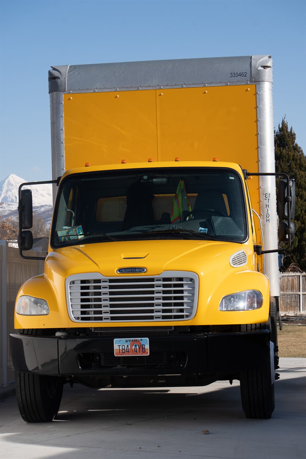 Bambara Logistics 26-foot Freightliner box truck with the Wasatch mountains behind it